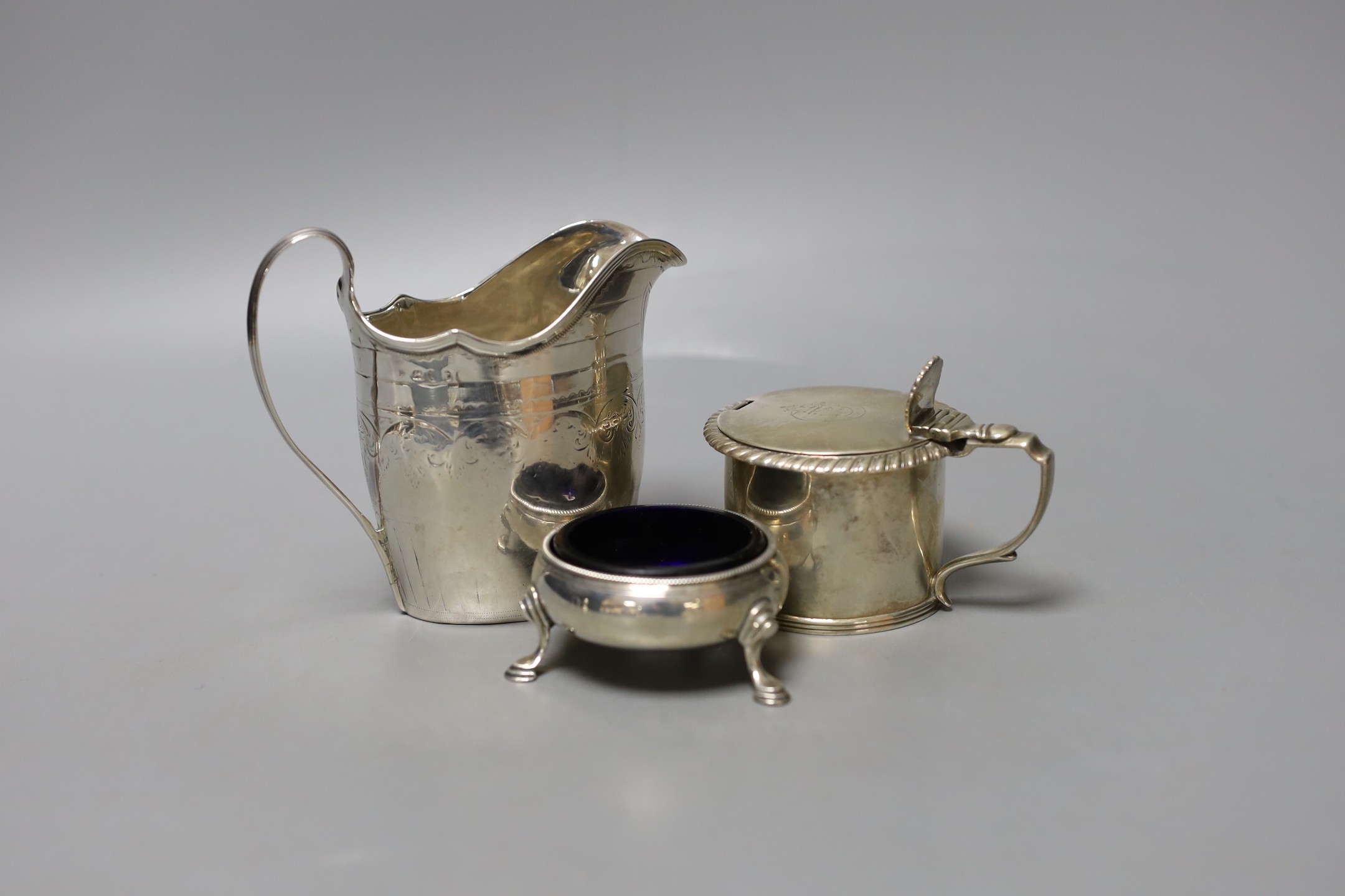 A George III silver cream jug, London, 1794, 10.3cm, a Georgian silver mustard pot and a Georgian silver salt.